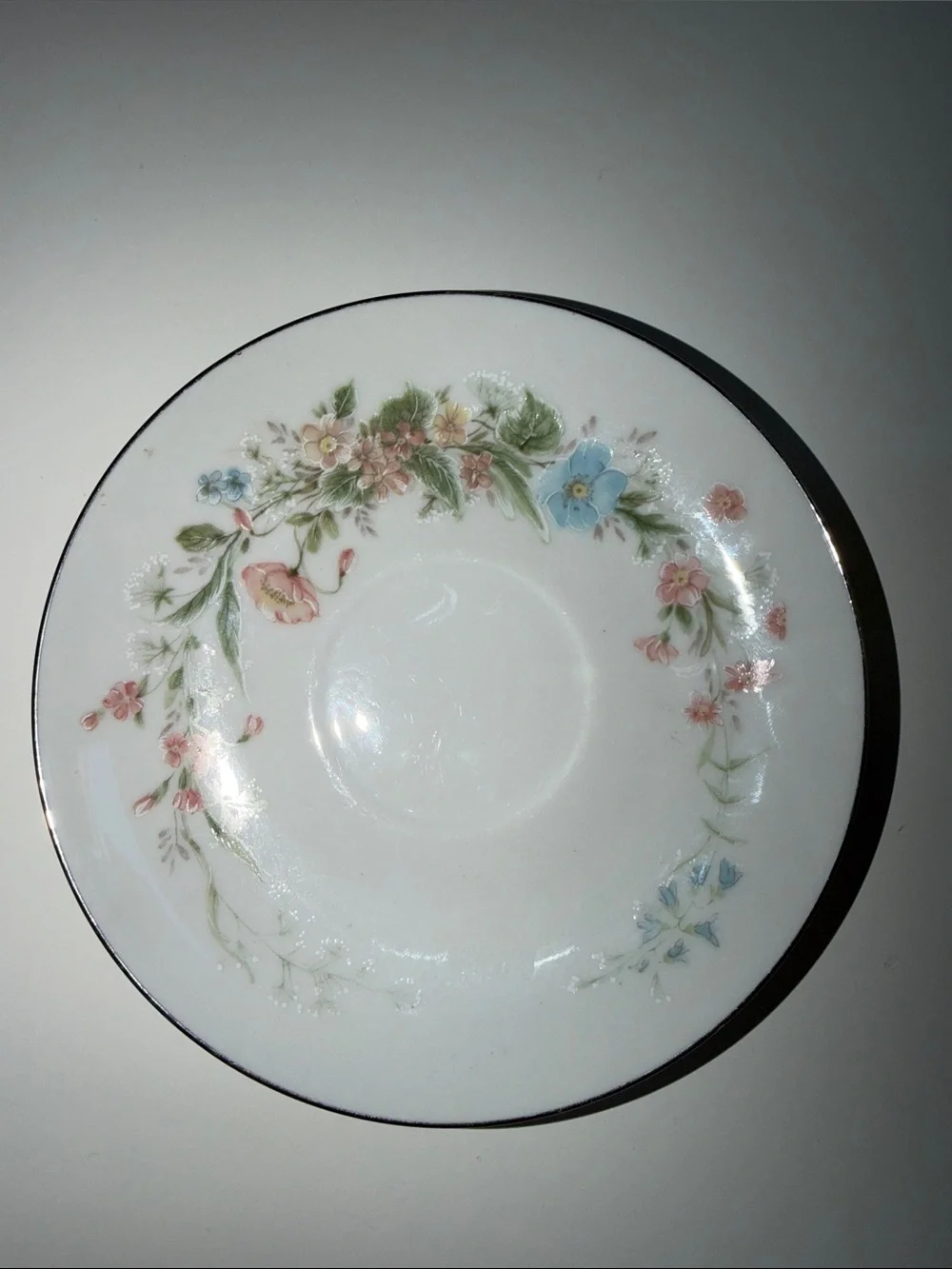 White Floral Porcelain Teacup and Saucer with Silver Trim